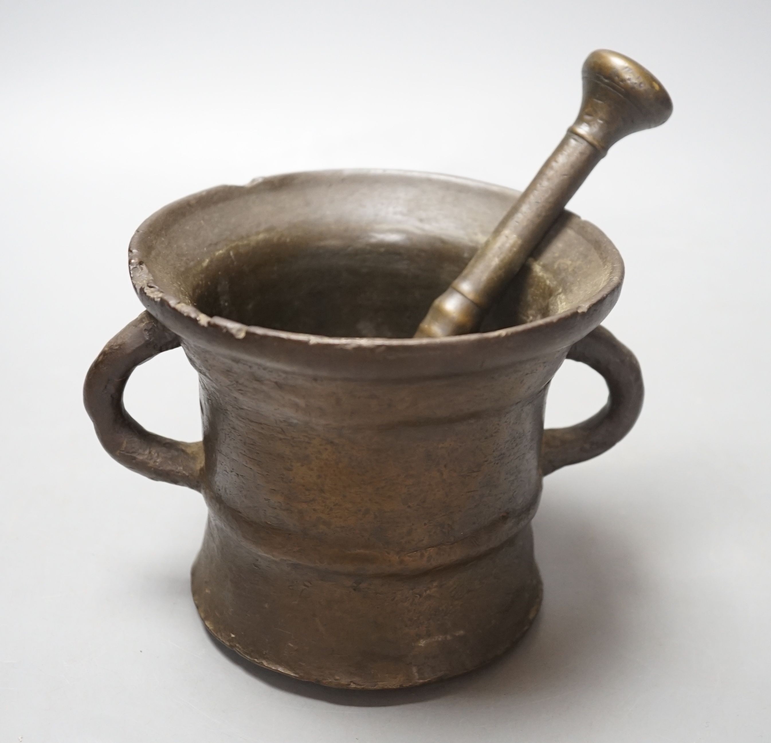 An 18th century bronze pestle and mortar